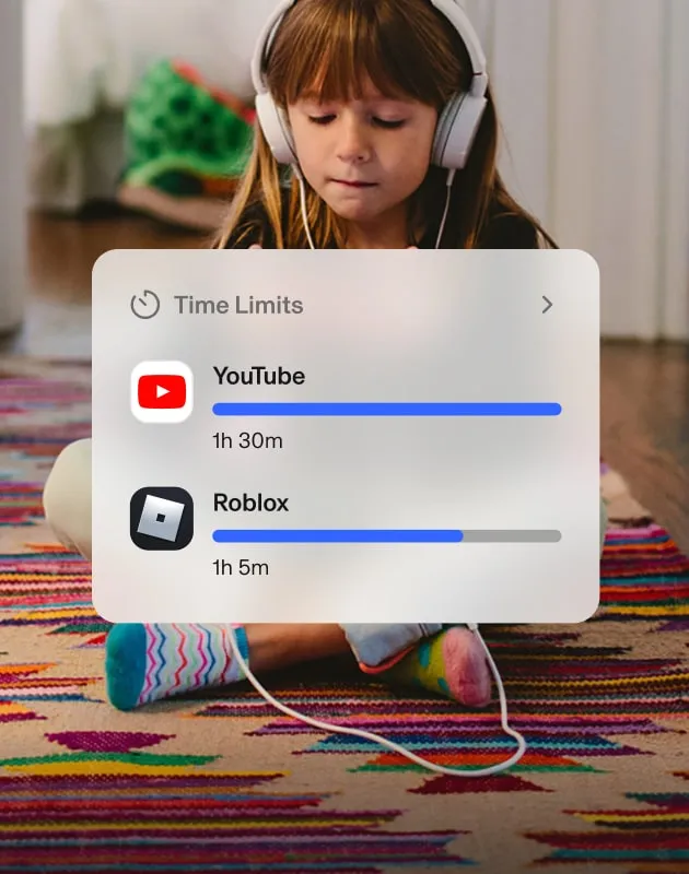 Child sitting cross-legged on the floor — using her phone and headphones — beside Aura popups about screen time limits